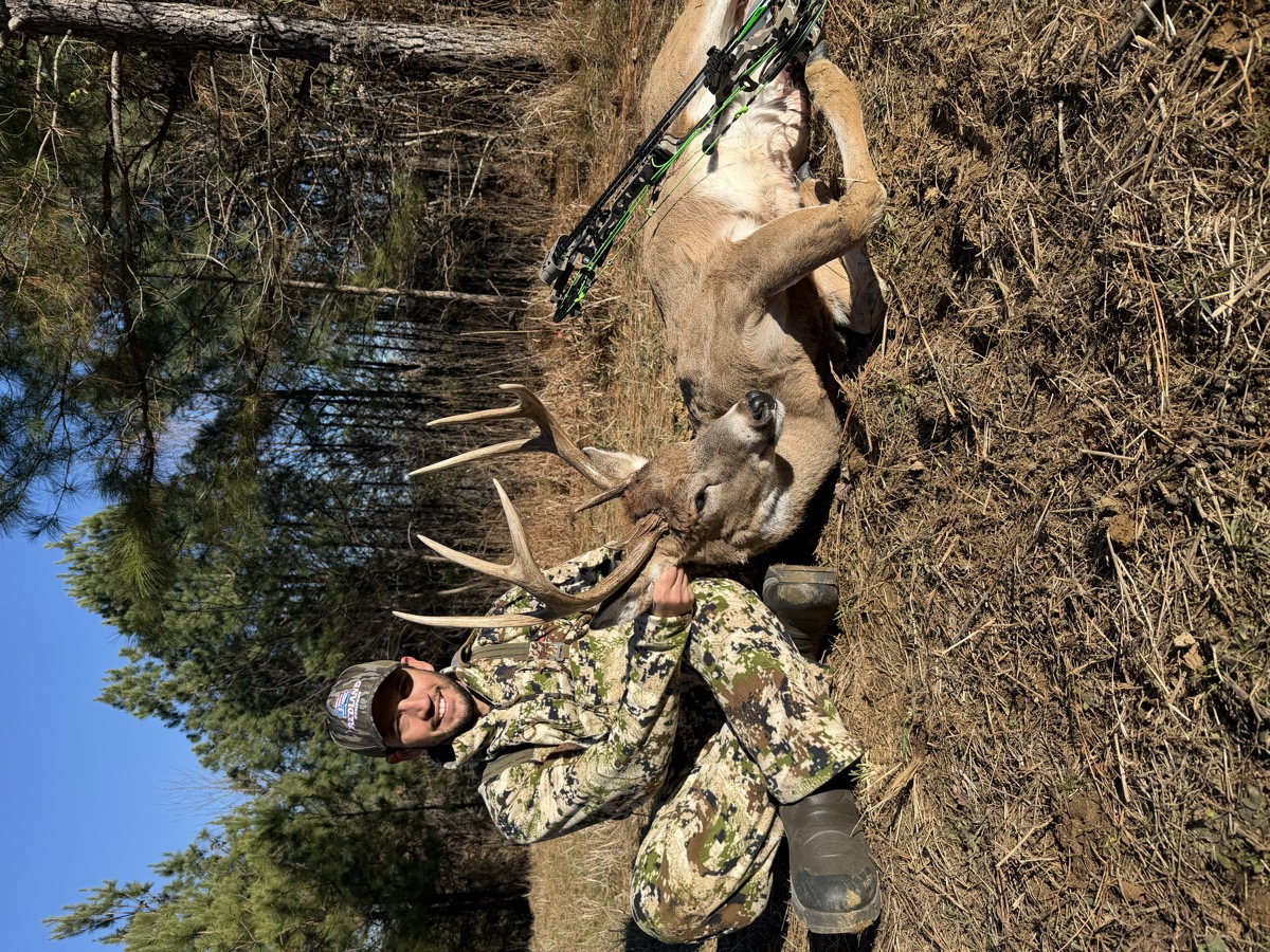 Hunter posing with mature whitetail
