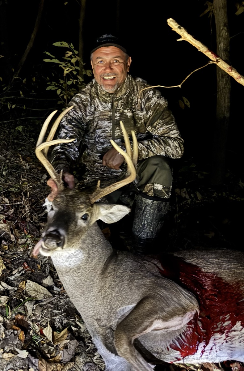 Hunter with heavy-antlered buck