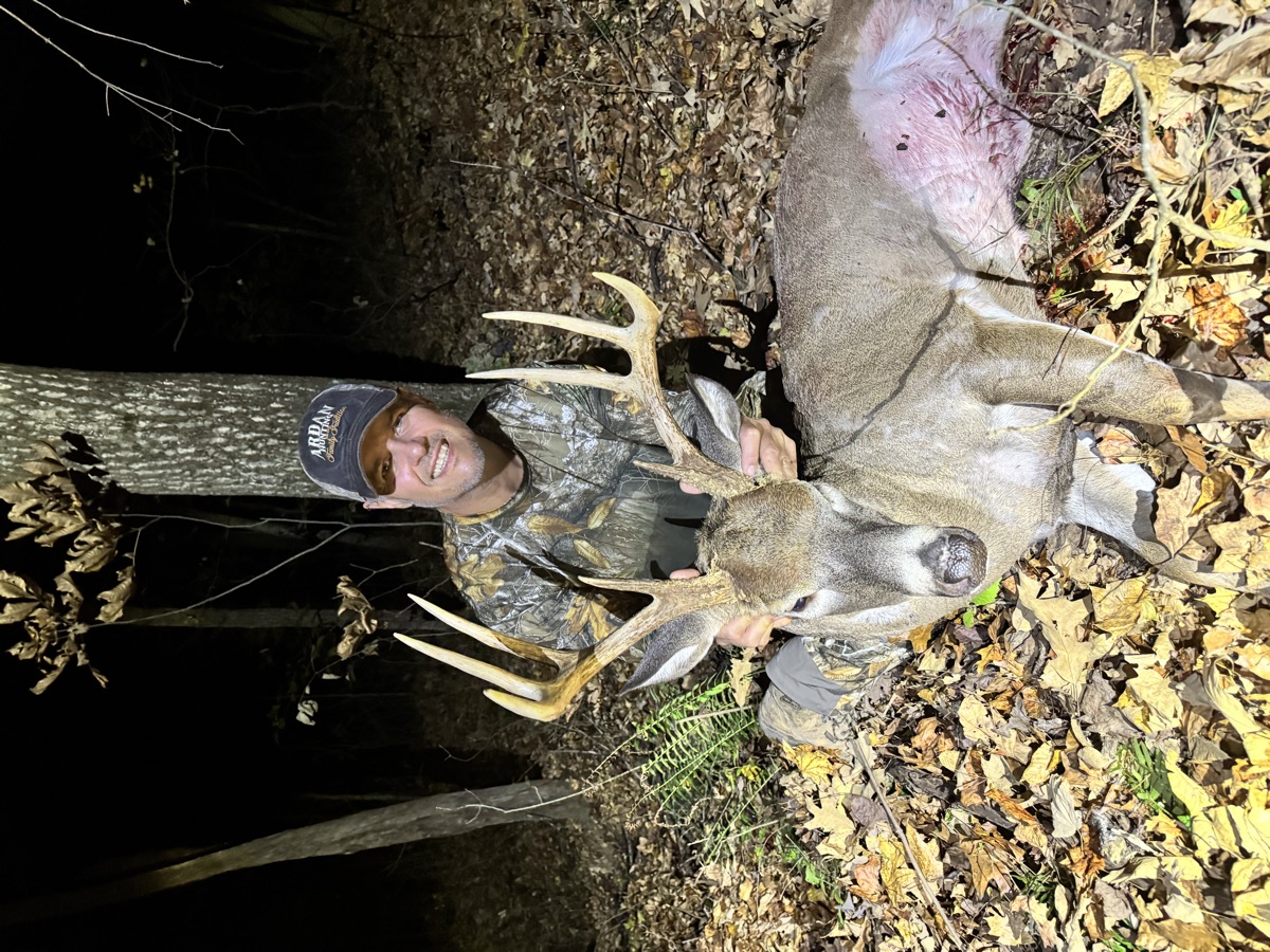 Bowhunter with mature whitetail buck
