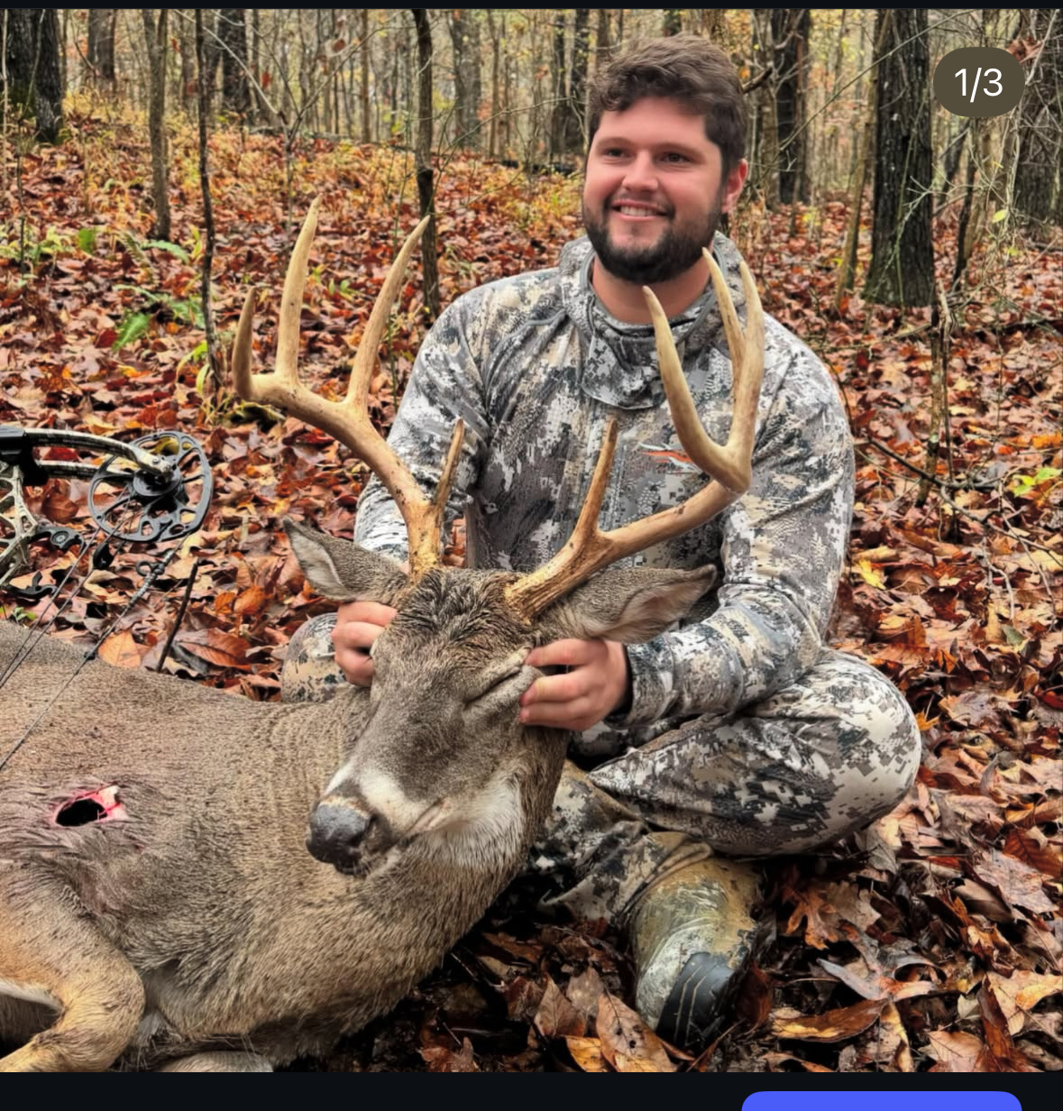 Hunter with trophy whitetail buck in autumn woods