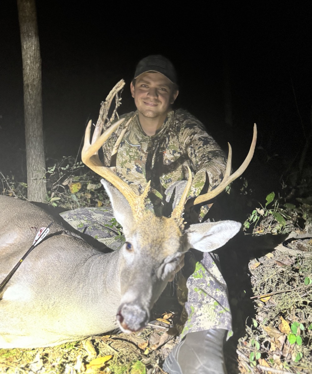 Hunter posing with mature buck