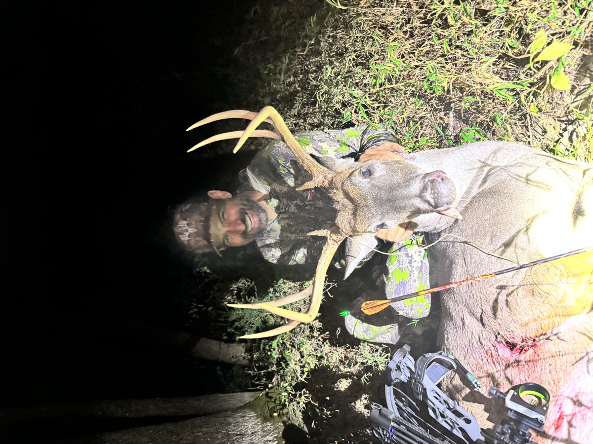 Bowhunter with a wide-racked whitetail