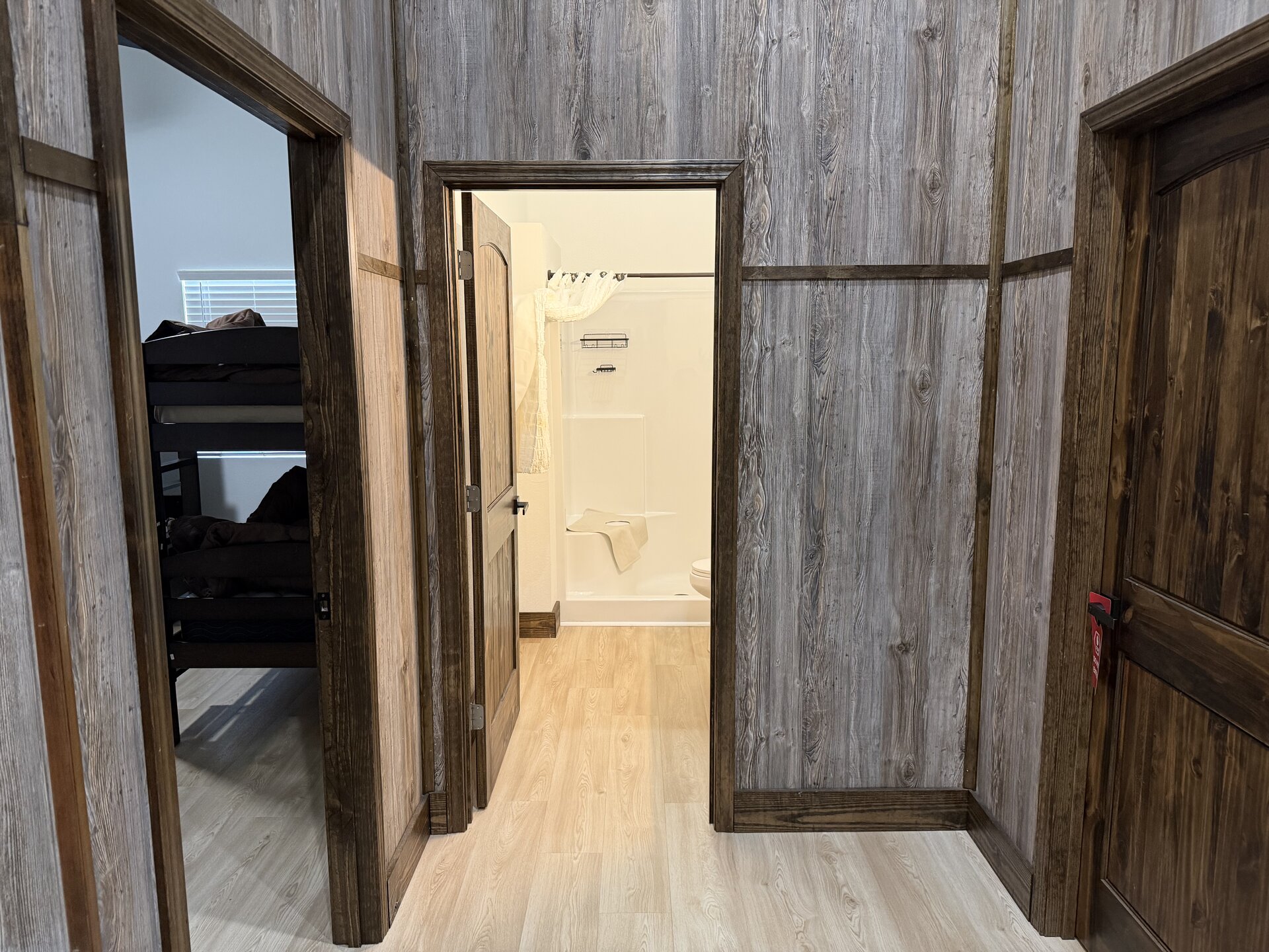 Guest wing showing a bedroom with bunk beds and an adjacent full bathroom
